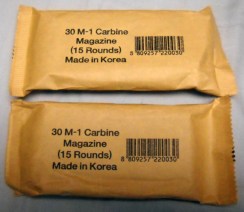 two Korean surplus 15-round M1 carbine magazines, still in paper packaging